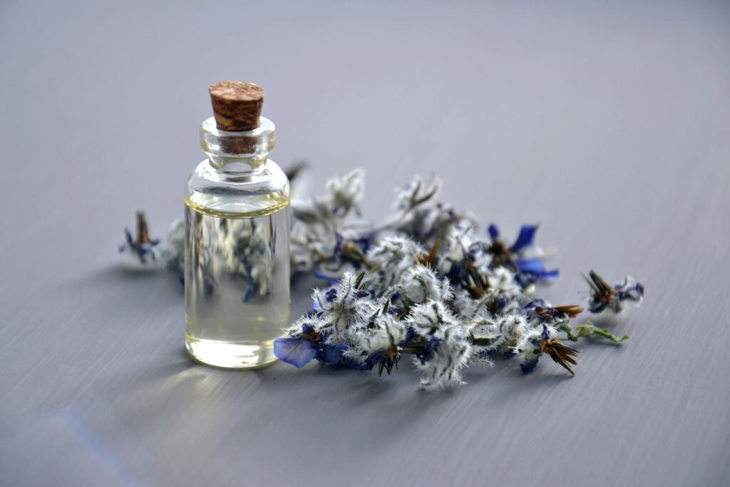 close-up of a lavender oil bottle with dried flowers for aromatherapy. perfect for wellness themes.